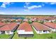Stunning aerial view of the neighborhood showcasing the homes with red tiled roofs and green lawns at 17214 Star Banks St, Wimauma, FL 33598