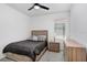 Cozy bedroom with neutral walls, a ceiling fan, a comfortable bed, and a dresser at 17214 Star Banks St, Wimauma, FL 33598