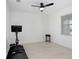 Versatile bonus room with tile floors, a ceiling fan, a window, and exercise equipment at 17214 Star Banks St, Wimauma, FL 33598