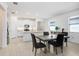 Bright dining area adjacent to the kitchen, featuring modern tile floors and ample natural light at 17214 Star Banks St, Wimauma, FL 33598