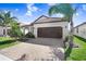 Charming single-story home featuring a tile roof, a two-car garage, and beautifully maintained landscaping at 17214 Star Banks St, Wimauma, FL 33598
