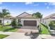 Charming single-story home featuring a tile roof, a two-car garage, and beautifully maintained landscaping at 17214 Star Banks St, Wimauma, FL 33598