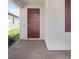 Inviting front entrance with a brick-paved porch and a stylish, modern door with glass pane at 17214 Star Banks St, Wimauma, FL 33598