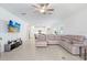 Spacious living room featuring a large sectional sofa, tile floors, and open access to the kitchen at 17214 Star Banks St, Wimauma, FL 33598