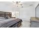 Comfortable main bedroom with stylish decor, a ceiling fan, and an ensuite bathroom at 17214 Star Banks St, Wimauma, FL 33598