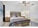 Comfortable main bedroom with stylish decor, a ceiling fan, and an ensuite bathroom at 17214 Star Banks St, Wimauma, FL 33598