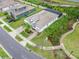 An elevated view of a property featuring a pool, lush landscaping, and a paver driveway at 19611 Cypress Bridge Dr, Odessa, FL 33556