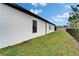 Well-maintained backyard with green lawn, privacy fence, and exterior of a white stucco home at 19611 Cypress Bridge Dr, Odessa, FL 33556