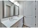 Bathroom with a double sink vanity with framed mirrors and modern fixtures at 19611 Cypress Bridge Dr, Odessa, FL 33556