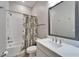 Stylish bathroom featuring a shower-tub combo, subway tiles and wood-look floors at 19611 Cypress Bridge Dr, Odessa, FL 33556