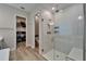 Elegant bathroom featuring a glass walk-in shower and organized walk-in closet at 19611 Cypress Bridge Dr, Odessa, FL 33556