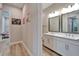 Bright bathroom with a double vanity, white cabinets and modern fixtures at 19611 Cypress Bridge Dr, Odessa, FL 33556