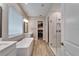 Stylish bathroom featuring a soaking tub, walk-in shower, and neutral wall colors at 19611 Cypress Bridge Dr, Odessa, FL 33556