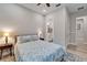 This bedroom features a comfortable bed, a ceiling fan, and an ensuite bathroom at 19611 Cypress Bridge Dr, Odessa, FL 33556