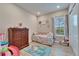 This bedroom features a dresser, a unicorn-themed rug, and a light-filled window at 19611 Cypress Bridge Dr, Odessa, FL 33556