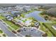 Aerial view of community pool, a lake and surrounding neighborhood with manicured lawns at 19611 Cypress Bridge Dr, Odessa, FL 33556
