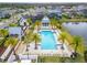 An aerial view of a large pool surrounded by palm trees, lounge chairs and manicured grounds at 19611 Cypress Bridge Dr, Odessa, FL 33556