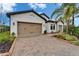 A lovely single-Gathering home with a manicured lawn, mature landscaping, and a paved driveway at 19611 Cypress Bridge Dr, Odessa, FL 33556