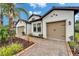 Beautiful home with a well manicured lawn and front flower beds leading to attached garages at 19611 Cypress Bridge Dr, Odessa, FL 33556