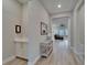 Bright hallway with wood floors and recessed lighting leading into the living space with comfortable seating at 19611 Cypress Bridge Dr, Odessa, FL 33556