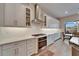 Bright kitchen with white cabinets, stainless steel hood, and quartz countertops at 19611 Cypress Bridge Dr, Odessa, FL 33556