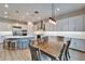 Open concept kitchen and dining area with white cabinets, light wood floors, and stainless steel appliances at 19611 Cypress Bridge Dr, Odessa, FL 33556