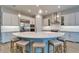 Modern kitchen with a central island, pendant lights, white cabinetry, and stainless steel appliances at 19611 Cypress Bridge Dr, Odessa, FL 33556