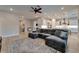 Open-concept living room featuring a sectional sofa, a kitchen, and an island with barstool seating at 19611 Cypress Bridge Dr, Odessa, FL 33556