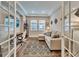 This comfortable living room has neutral walls, beautiful windows, and French doors at 19611 Cypress Bridge Dr, Odessa, FL 33556