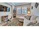 Cozy living room featuring a comfortable couch, workspace, and a stylish area rug at 19611 Cypress Bridge Dr, Odessa, FL 33556