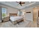 Spacious main bedroom with wood furnishings, tray ceilings, and ensuite bathroom access at 19611 Cypress Bridge Dr, Odessa, FL 33556