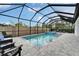 Enclosed pool and patio with blue tiling, lounge chairs, and privacy fence for outdoor relaxation at 19611 Cypress Bridge Dr, Odessa, FL 33556