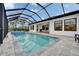A screened pool with deck, outdoor dining, and exterior views provides a relaxing atmosphere at 19611 Cypress Bridge Dr, Odessa, FL 33556
