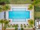 Aerial view of a sparkling pool lined with palm trees and lounge chairs, perfect for relaxing and enjoying the community at 19611 Cypress Bridge Dr, Odessa, FL 33556