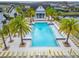 Stunning community pool featuring lush palm trees and plenty of lounge chairs for relaxing and enjoying the sunshine at 19611 Cypress Bridge Dr, Odessa, FL 33556