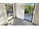 Bright room featuring balcony access through sliding doors and scenic outdoor views at 2011 Arbor Dr, Clearwater, FL 33760
