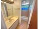 This tiled bathroom features a vanity with one sink and a separate water closet that includes the bathtub at 2011 Arbor Dr, Clearwater, FL 33760