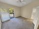 Inviting bedroom that features neutral colors, carpeted floors, and sliding door access to a private balcony at 2011 Arbor Dr, Clearwater, FL 33760