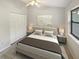 Serene bedroom featuring neutral colors, minimalist decor, and ample natural light from a window at 2011 Arbor Dr, Clearwater, FL 33760