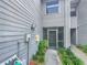 Inviting entryway featuring a secure screen door, neat landscaping and neutral siding, offering curb appeal at 2011 Arbor Dr, Clearwater, FL 33760