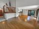 Expansive living room with hardwood floors, a staircase and view into the kitchen, great for entertaining at 2011 Arbor Dr, Clearwater, FL 33760