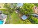 Aerial view of backyard with a gazebo, storage shed, and lush greenery near the lake at 22119 Weeks Blvd, Land O Lakes, FL 34639