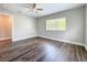Bedroom showing new flooring, ceiling fan and window letting in lots of light at 22119 Weeks Blvd, Land O Lakes, FL 34639