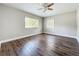 Open room showing new flooring, ceiling fan and windows with great light at 22119 Weeks Blvd, Land O Lakes, FL 34639