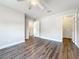 Large bedroom with new flooring, ceiling fan and view into the hallway at 22119 Weeks Blvd, Land O Lakes, FL 34639