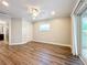 Bright bedroom features wood floors, ceiling fan, and a sliding glass door with backyard access at 22119 Weeks Blvd, Land O Lakes, FL 34639