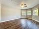 Bedroom features new floors, ceiling fan and multiple windows at 22119 Weeks Blvd, Land O Lakes, FL 34639