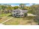 Charming two-story home features a unique turret-style entryway and a well-maintained lawn at 22119 Weeks Blvd, Land O Lakes, FL 34639