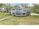 Charming two-story home features a unique turret-style entryway and a well-maintained lawn at 22119 Weeks Blvd, Land O Lakes, FL 34639