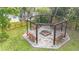 Outdoor firepit with swing seating and wooden pergola at 22119 Weeks Blvd, Land O Lakes, FL 34639